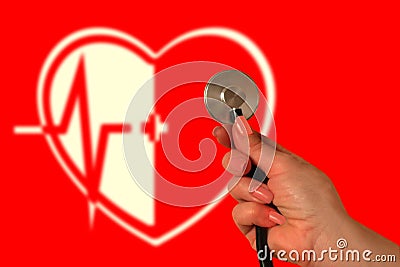 Cardio therapy concept. Hand with stethoscope on red background. Blurred image of heart, medical cross and electrocardiogram. Stock Photo