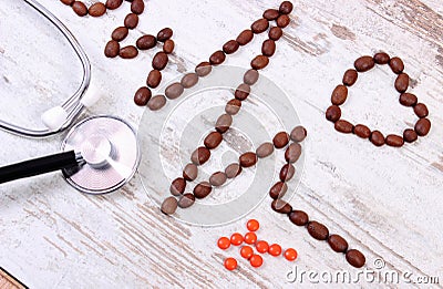 Cardiogram line of coffee grains, stethoscope and supplement pills, medicine and healthcare concept Stock Photo