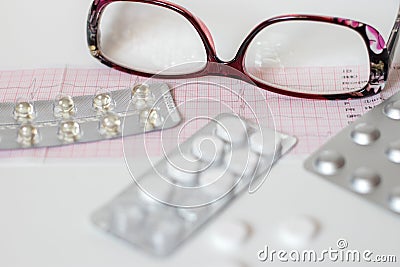 Cardiogram results on paper and pills, heart health Stock Photo