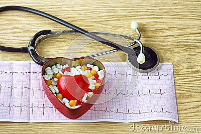 Cardiogram, stethoscope, with tablets box and red heart Stock Photo