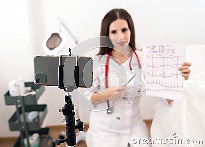 A cardiologist doctor with a cardiology test giving health care advice online by webcam videochat and consulting distant patient. Stock Photo