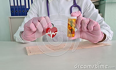 Cardiologist doctor holds medical pills in shape of heart Stock Photo