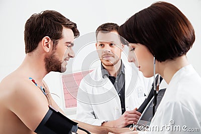 Cardiologist and nurse performs the stress test to a patient Stock Photo