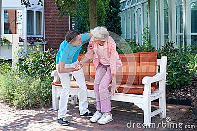 Care assistant tending to a senior lady. Stock Photo