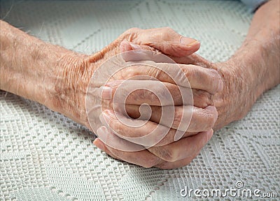 Care is at home of elderly. Old people holding hands. Stock Photo