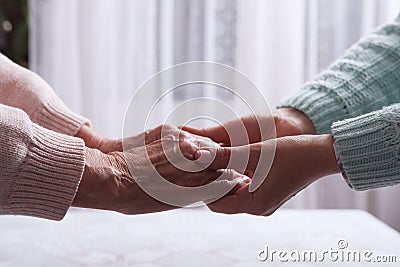 Care is at home of elderly. Senior woman with their caregiver at home. Concept of health care for elderly old people Stock Photo