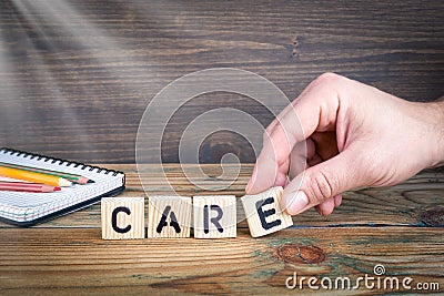 Care. Wooden letters on the office desk, informative and communication background Stock Photo