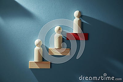 Career growth. Career development. Goal achievement. Career path. Wooden figure placed in increasing order on red block Stock Photo