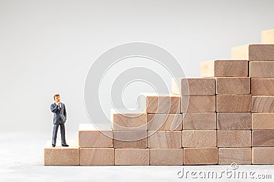 Career ladder. Steps up as symbol of the path to the goal. Man in suit stands at the beginning of the path to successful Stock Photo