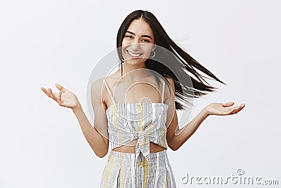 Carefree attractive girlfriend walking on seashore with boyfriend on windy weather, hair floats on wind and woman Stock Photo