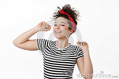 Carefree attractive woman in headband, dancing and having fun, smiling and laughing relaxed, resting at party, standing Stock Photo