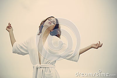 Carefree beauty at home. Woman with closed eyes relax in bathrobe. Young woman with makeup and fresh skin, skincare Stock Photo