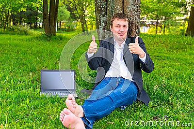 Carefree businessman in the park Stock Photo