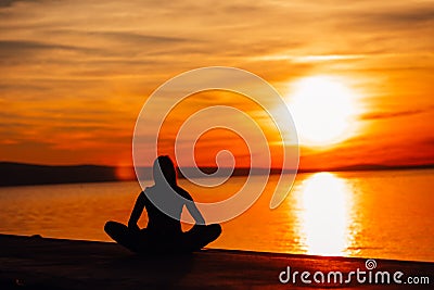 Carefree calm woman meditating in nature.Finding inner peace.Yoga practice.Spiritual healing lifestyle.Enjoying peace,anti-stress Stock Photo