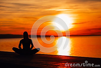 Carefree calm woman meditating in nature.Finding inner peace.Yoga practice.Spiritual healing lifestyle.Enjoying peace,anti-stress Stock Photo