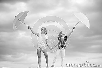 Carefree children outdoors. Freedom and freshness. Weather forecast. Weather changing. Girls friends with umbrellas Stock Photo