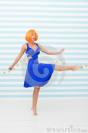 Carefree girl with crazy look makes step. so much fun. crazy girl with orange hair dancing barefoot. totally carefree Stock Photo