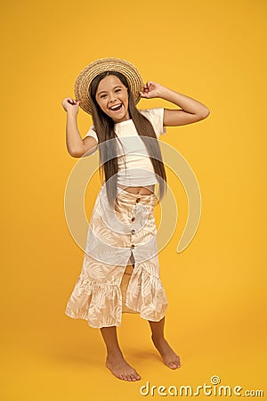 carefree and happy kid barefoot. summer beach fashion. childhood happiness. small girl wear straw hat. cheerful child on Stock Photo