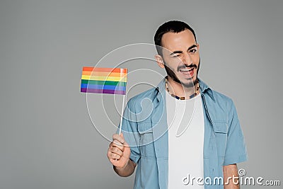 Carefree homosexual man holding lgbt flag Stock Photo