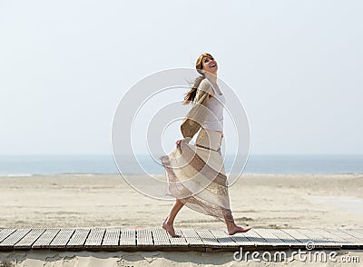 Carefree middle aged woman walking barefoot Stock Photo