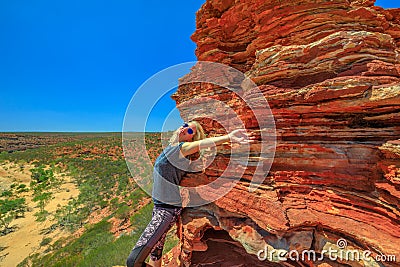Kalbarri woman climbing Stock Photo
