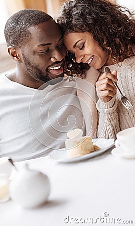 Careful African American couple enjoying the dessert in the cafe Stock Photo