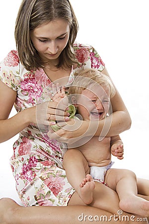 Careful mother dresses the daughter Stock Photo