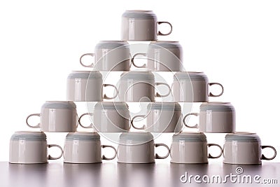 Carefully stacked pyramid of drying coffee cups Stock Photo