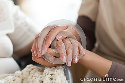 Caregiver holding senior woman`s hands Stock Photo