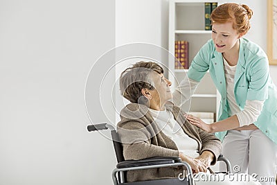 Caregiver in nursing home Stock Photo