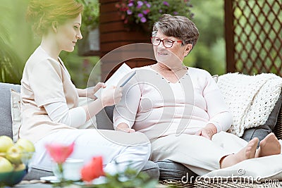 Caregiver reading journal Stock Photo