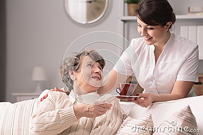 Caregiver serving the tea Stock Photo