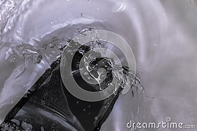 From careless handling phone fell in water, the top view Stock Photo