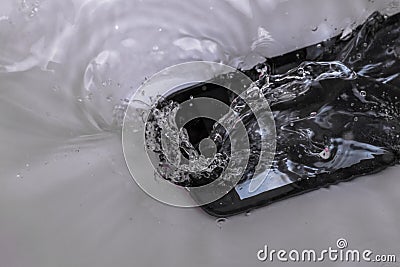 From careless handling phone fell in water, the top view Stock Photo