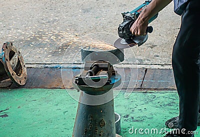 Careless worker use hand grinding without safety gloves, outlet generating electricity sparks Stock Photo