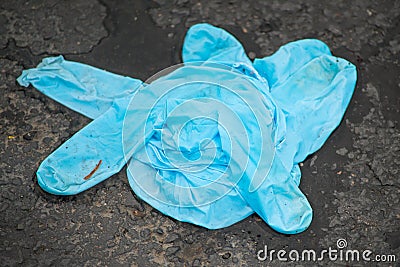 A Blue Latex Glove Carelessly Discarded Stock Photo