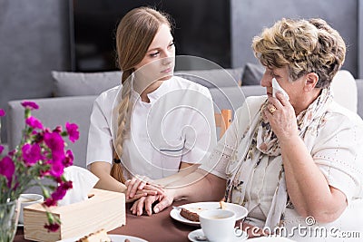 Carer supporting ill, sad senior Stock Photo