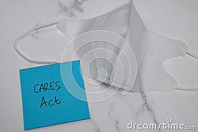 Cares Act write on sticky note isolated on wooden table Stock Photo