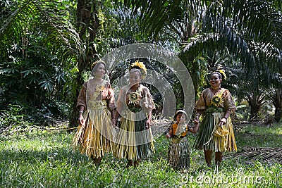 Malaysia`s indigenous Mah Meri walk in oil palm plantation Editorial Stock Photo