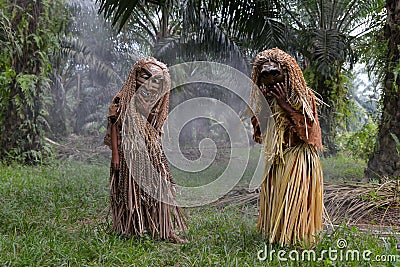 Malaysia`s indigenous tribesmen wear mask in oil palm estate Editorial Stock Photo