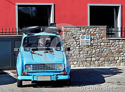 Renault 4 light blue parked. This is a rally version with spare wheels on the roof, additional headlights and shovel on the hood. Editorial Stock Photo