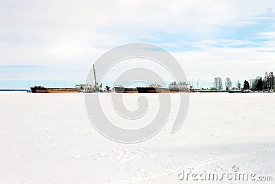 Cargo barges stand in port in the winter season on Lake Onega Stock Photo