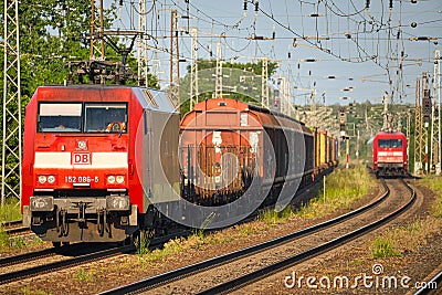 Cargo class locomotive with colorful wagons passing through Saarmund, Germany Editorial Stock Photo