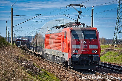 Cargo class locomotive with red wagons passing through Saarmund, Germany Editorial Stock Photo