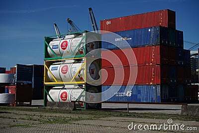 Cargo container and gaz tanks stacked on LeixÃµes harbor Matosinhos Portugal wait to be shipped by cargo ship Editorial Stock Photo