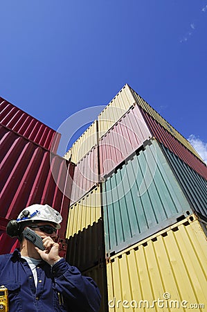 Cargo containers and dock worker Stock Photo