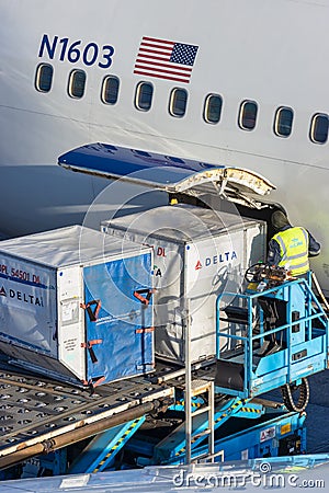 Cargo containers loaded on board of a Delta Airlines airplane on Schiphol Airport, The Netherlands Editorial Stock Photo