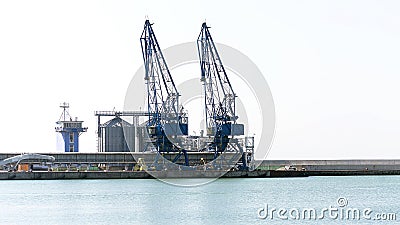 Cargo cranes and grain dryers Stock Photo