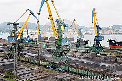 Cargo handling of metal on a ship in Nakhodka, Russia Editorial Stock Photo