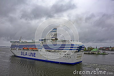 Cargo-passenger cruise ferry ship Silja Serenade by Tallink leaving South harbor of Helsinki, Finland at rainy overcast day Editorial Stock Photo